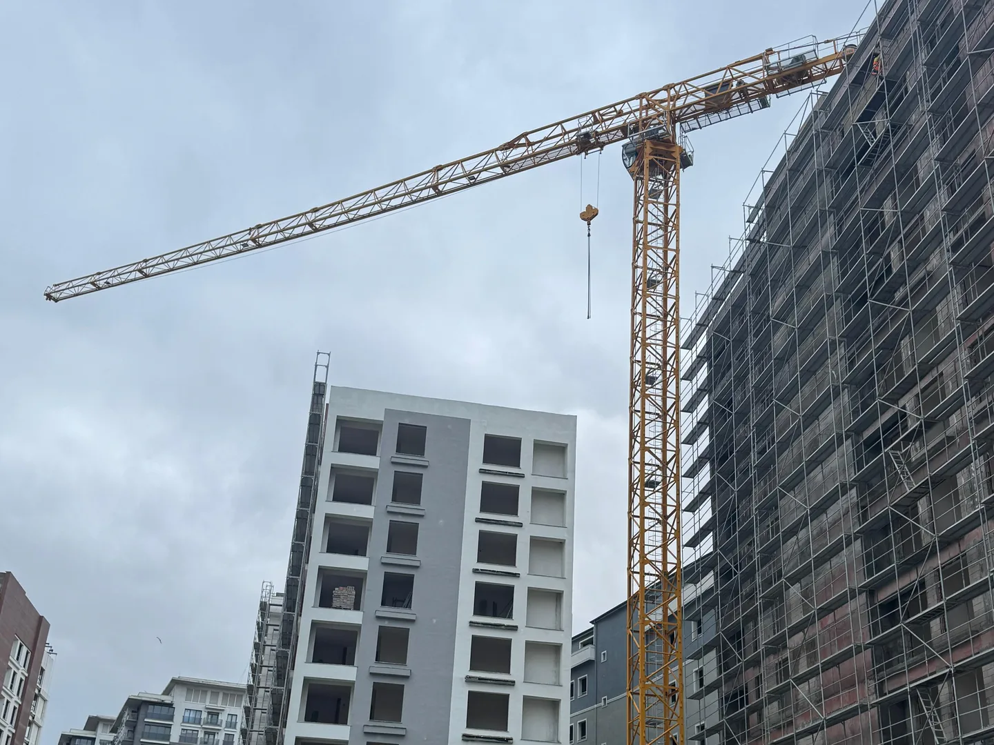 Tower crane with horizontal jib on an active construction site